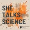 Text reads She Talks Science in front of an orange and grey explosion of paint on a beige background